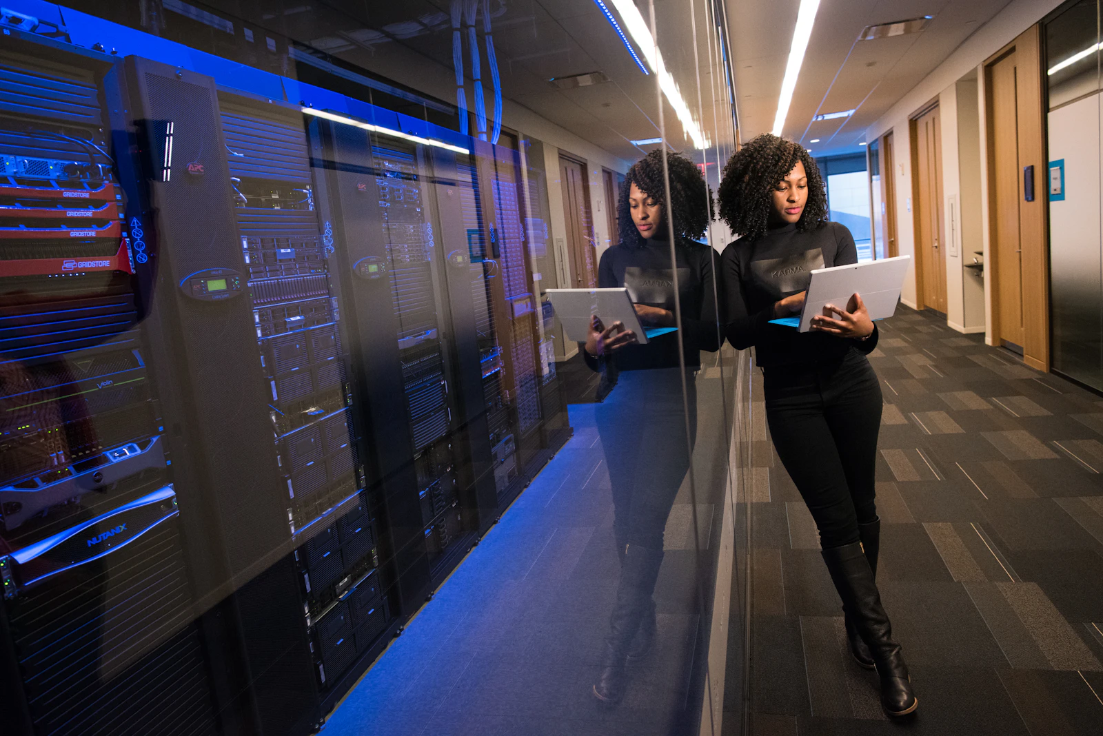 IT engineer reviewing enterprise server infrastructure in a data centre